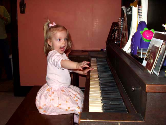 Eva plays piano.©Gretchen  Shie Miller 2006.